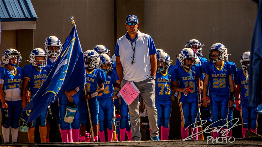 Garrett coaching youth football Eagles on game day